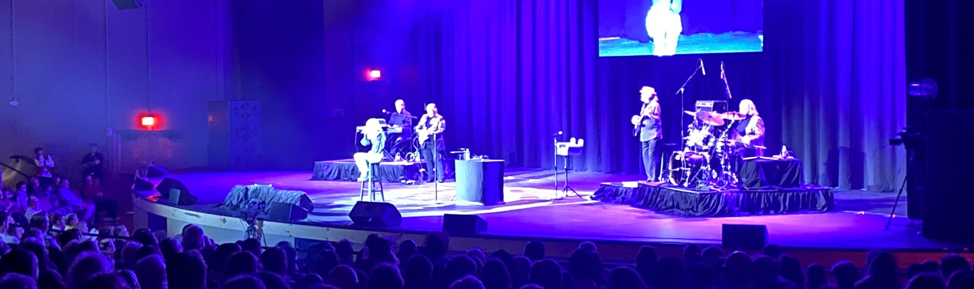 signer on stage in chair washed out by the lights Biloxi